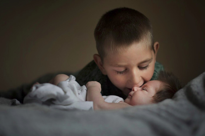 Photo of a child and a baby